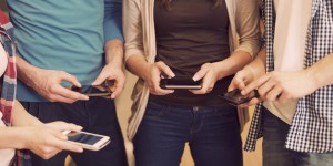 Close up of people with contemporary mobile phones